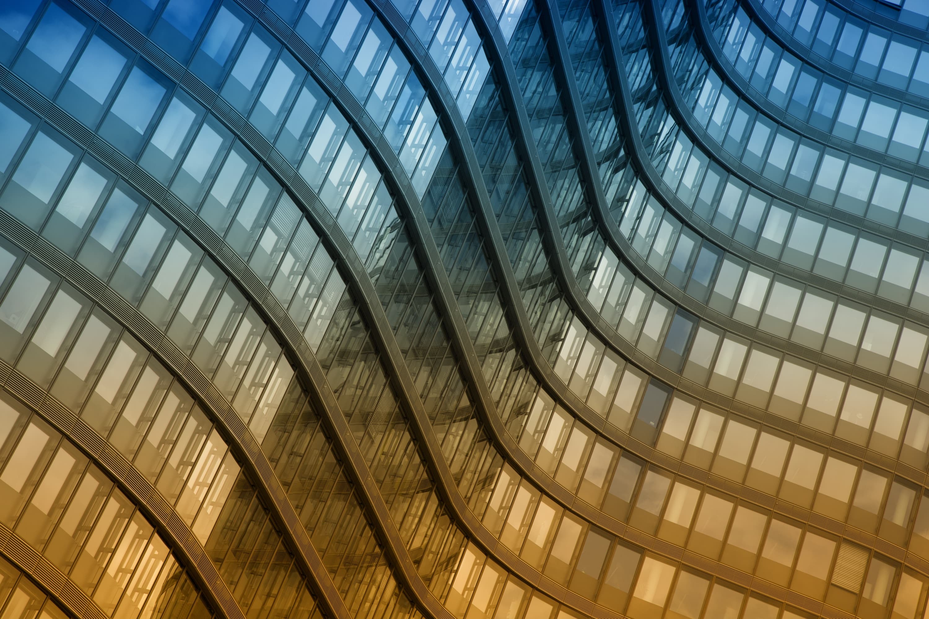 Curving glass and steel facade of a modern office building